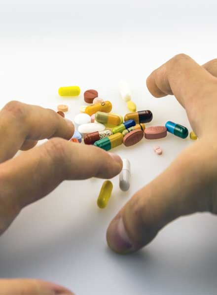 hand going to grab capsules